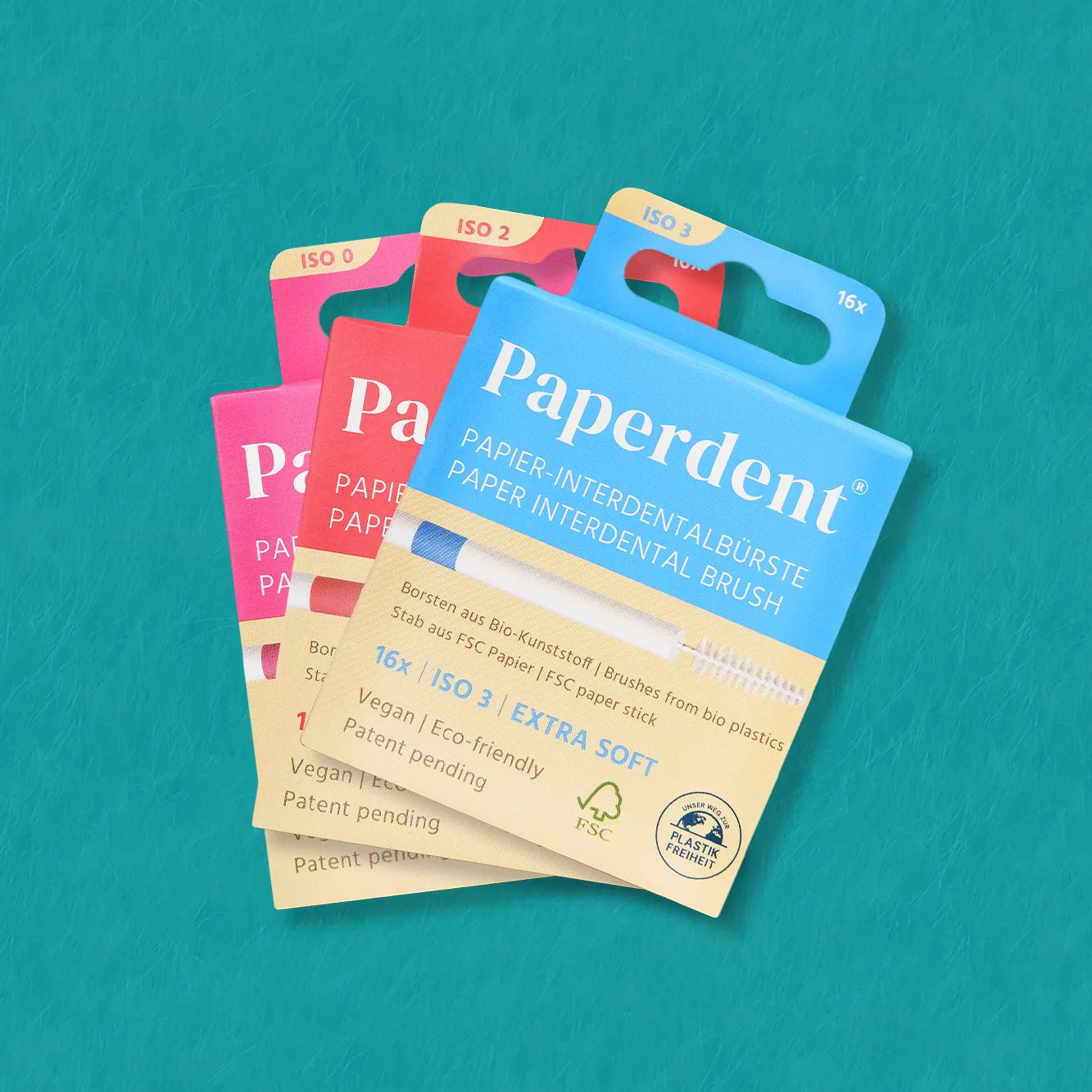 Paperdent Interdentalbürste aus Papier grün-blauer Hintergrund